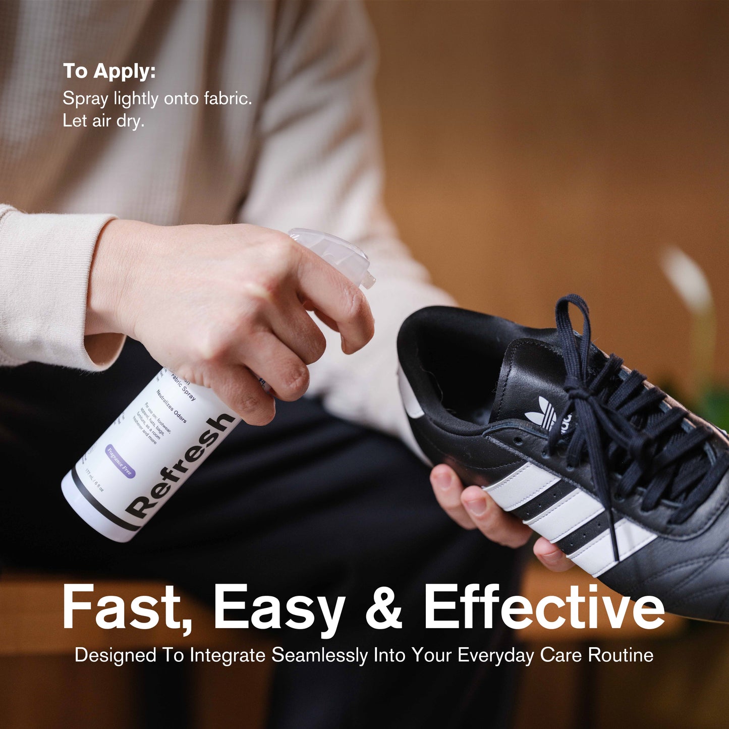 Person using a bottle of Refresh Spray on a black and white sneaker with certification icons and text.