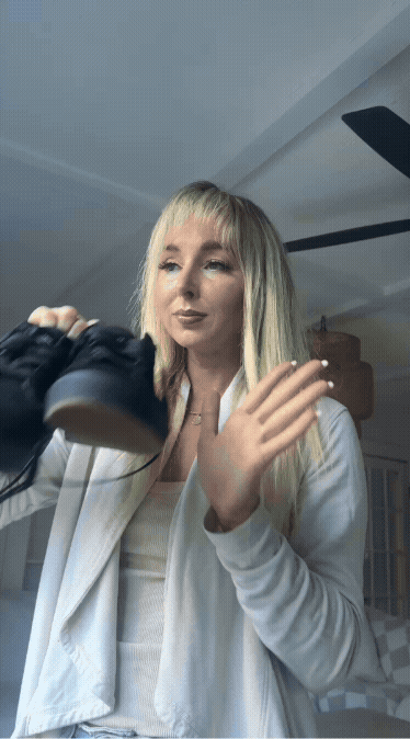 GIF of a woman using Refresh Spray on a pair of stinky black shoes to make them smell fresh again.