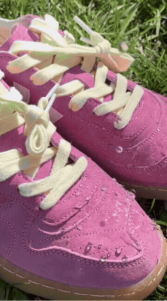 GIF of someone using Repel Spray on a pair of pink shoes.