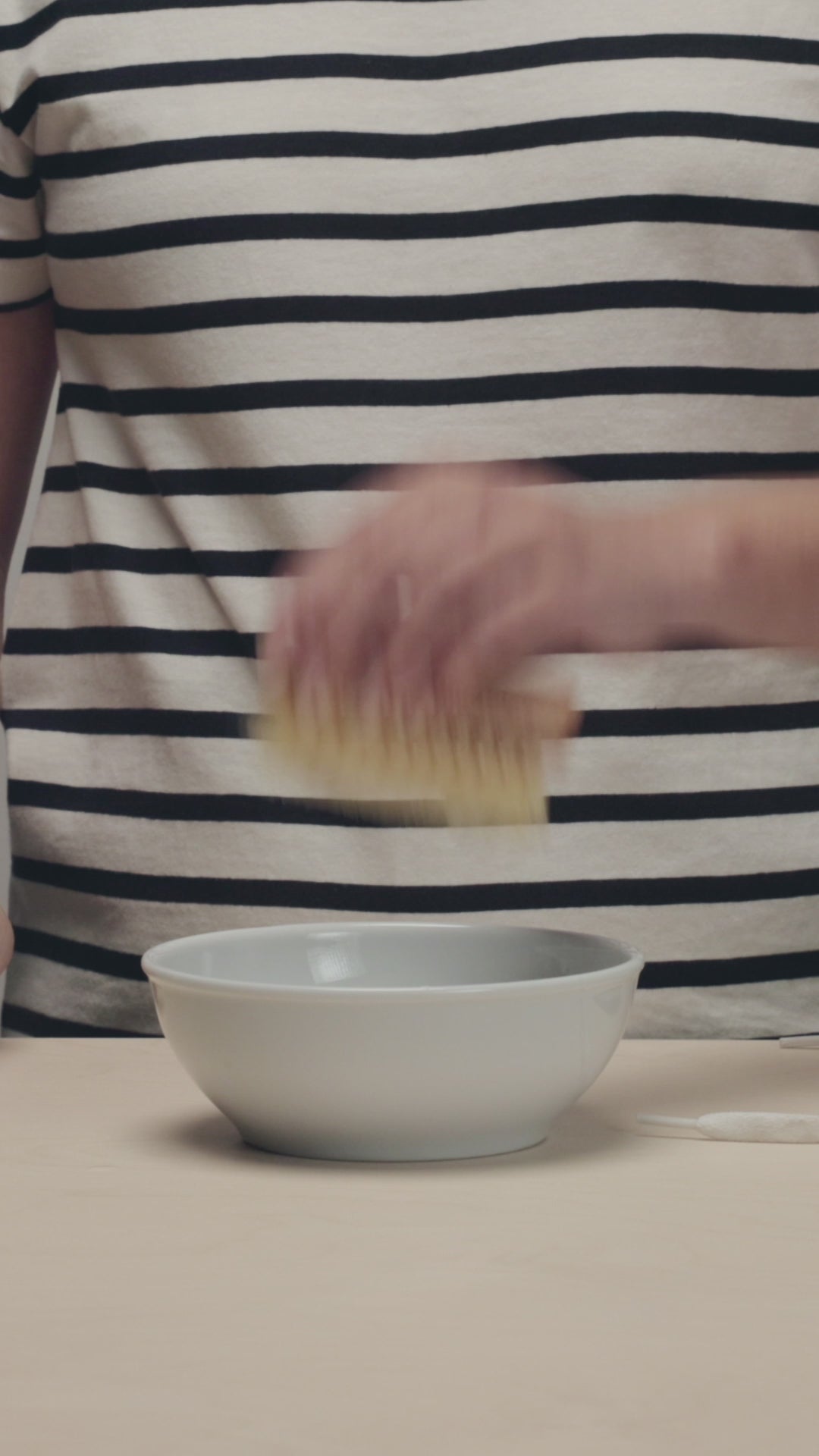 SHAKING OFF EXCESS LIQUID FROM A JASON MARKK DURABLES BRUSH THEN SCRUBBING A WHITE NIKE AIR FORCE 1